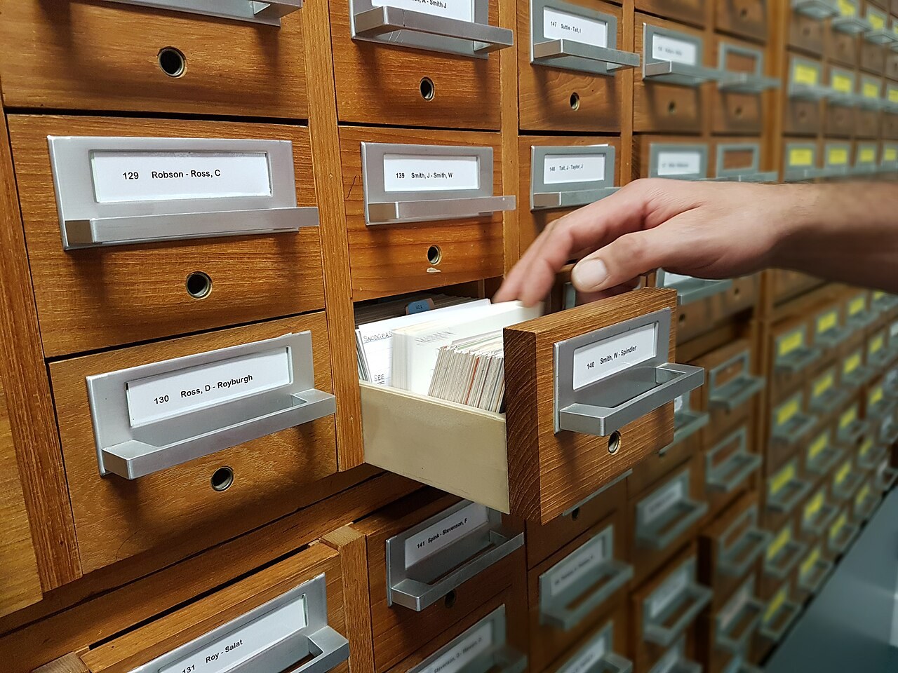 A hand using a filing cabinet. File illustration of record keeping, not the Finance Ministry handover.