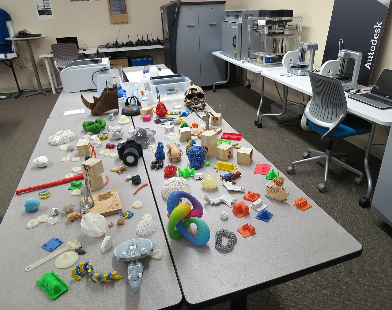 An assortment of 3D-printed objects displayed at NASA in a file photograph. These are contextual examples, not the X-Hinges research prototypes.